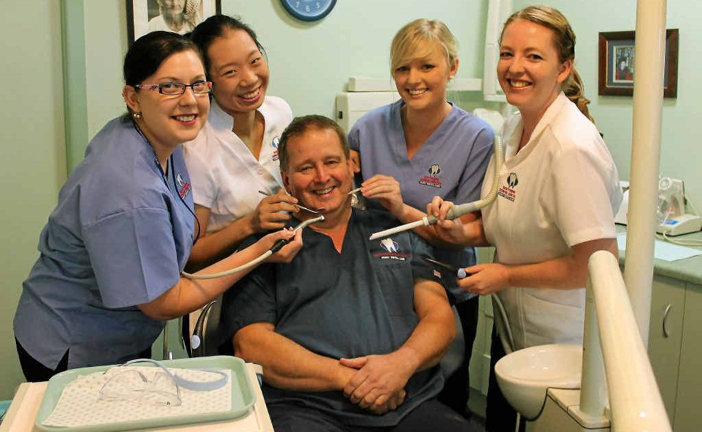 Hollie Craike, Katherine Chan, Rachael Eddison and Kylie Wright are happy to give boss Mike Geisel the dental once over. Hollie Craike, Katherine Chan, Rachael Eddison and Kylie Wright are happy to give boss Mike Geisel the dental once over.